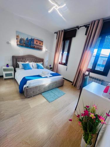 a bedroom with a bed and a table with flowers at Alisa house Venice in Venice