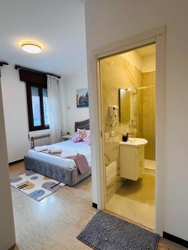 a bedroom with a bed and a sink and a mirror at Alisa house Venice in Venice