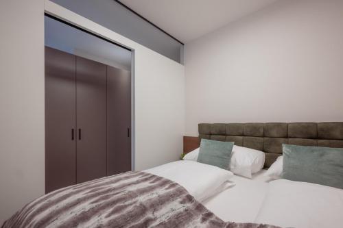 a bedroom with a bed and a large sliding glass door at Design Apartment Schladming in Schladming