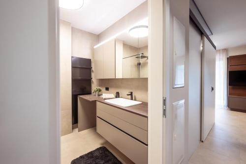 a kitchen with a sink and a counter top at Design Apartment Schladming in Schladming