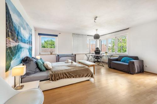a living room with a bed and a couch at Feriendomizil Brunnenberg in Sipplingen