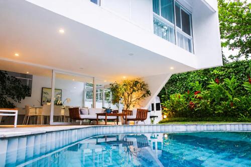 an exterior view of a house with a swimming pool at Savay Hotel Boutique - Guarujá in Guarujá