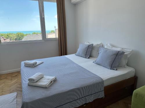 a bedroom with a large bed with towels on it at Guest Rooms Boutique Varna in Varna City