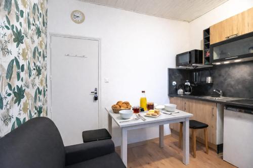a small kitchen with a table with food on it at Studio LEntre Nous in Saint-Pierre-de-Chartreuse