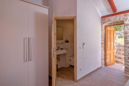 a bathroom with a sink and a toilet in a room at Stone Villa Marjan in Pitve