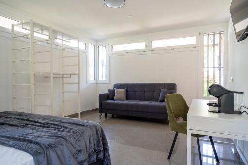 a bedroom with a bed and a couch and a desk at Marghera Venice Link Rooms in Venice