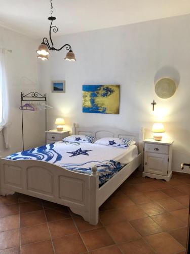 a bedroom with a bed and two night stands at La Casa del Vento Plemmirio in Plemmirio