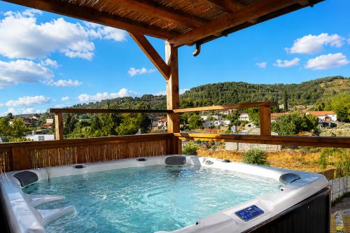 a hot tub on the deck of a house at וילה מקסים בחוסן - וילה מהממת עם בריכה, ג'קוזי וסאונה in H̱osen