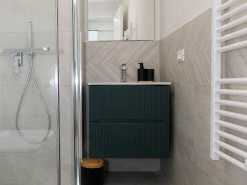 a bathroom with a green sink and a shower at Casa di Giò Apartment, Pool, 200m from Lake Garda in Gardone Riviera
