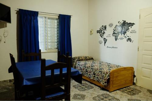 a bedroom with a bed and a map of the world on the wall at Cabañas Yunyay in Villa Cura Brochero