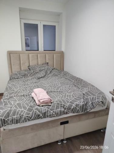 a bed with a pink towel on top of it at L2 Toplica PK in Prokuplje
