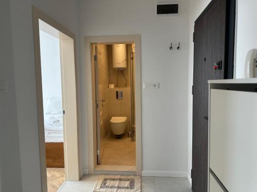 a bathroom with a door leading to a toilet at Guest Rooms Boutique Varna in Varna City