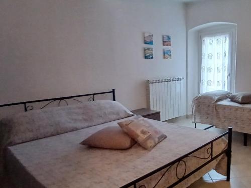 a bedroom with a bed with a pillow on it at Appartamento Casa Margi in Ameglia