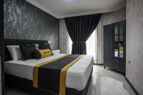 a bedroom with a large bed in a room at Çınar Suit Hotel in Buca