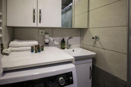 a bathroom with a sink and a white counter top at Çınar Suit Hotel in Buca