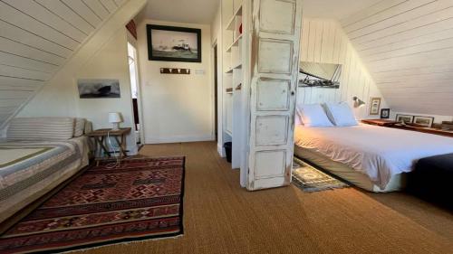 a bedroom with a bed and a ladder in it at Chambre d'hôtes Ouest Laurent Vidal in Plouharnel