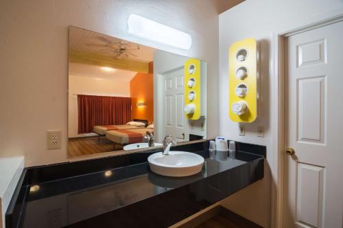 a bathroom with a sink and a large mirror at Motel 6-Globe, AZ in Globe