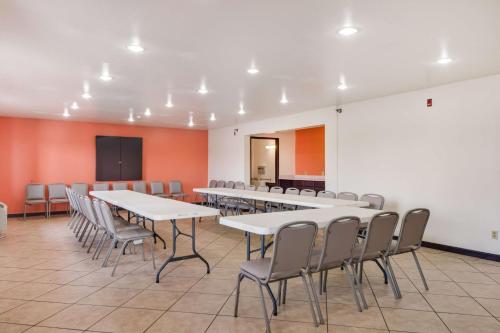a conference room with tables and chairs and a chalkboard at Motel 6-Brownsville, TX North in Brownsville