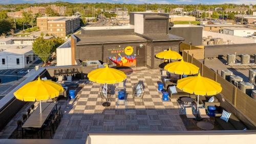 an overhead view of a patio with yellow umbrellas at The Carter by AvantStay in Nashville