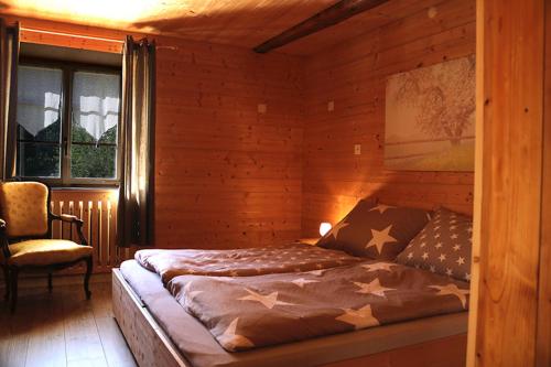 a bedroom with a bed with stars on it at Au Cheval Blanc in Asuel