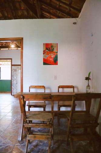 a wooden table and chairs in a room at LahSelva Pousada e Hostel in Itacaré
