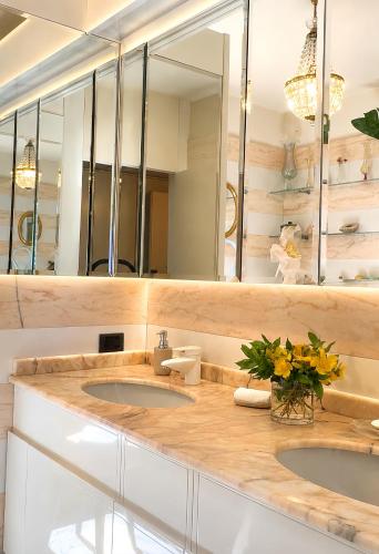 a bathroom with two sinks and a mirror at Villa Nuvola Suites in Fiorano Modenese