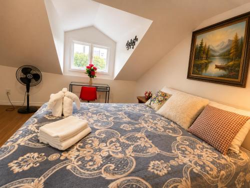 a bedroom with a large bed with a blue rug at ChinaTown Boutique Rooms in Toronto
