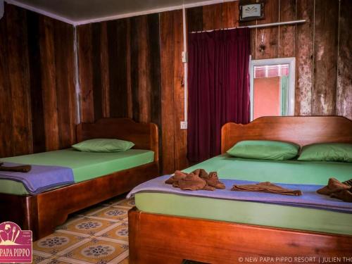 A bed or beds in a room at New Papa Pippo Resort