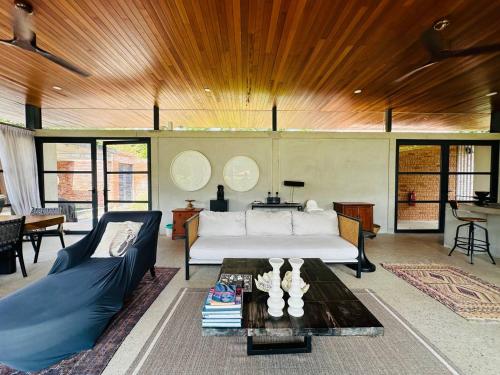 a living room with a couch and a table at Laman Villa Port Dickson in Port Dickson