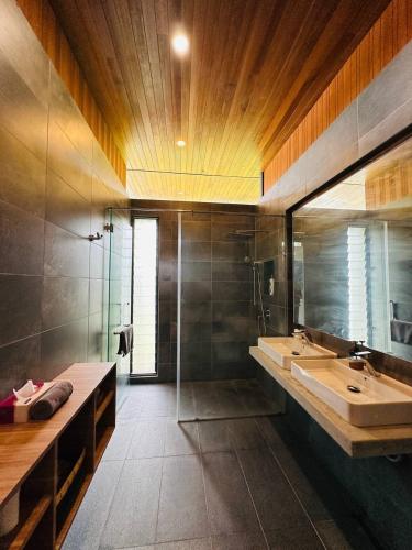 a bathroom with a tub and a sink and a shower at Laman Villa Port Dickson in Port Dickson