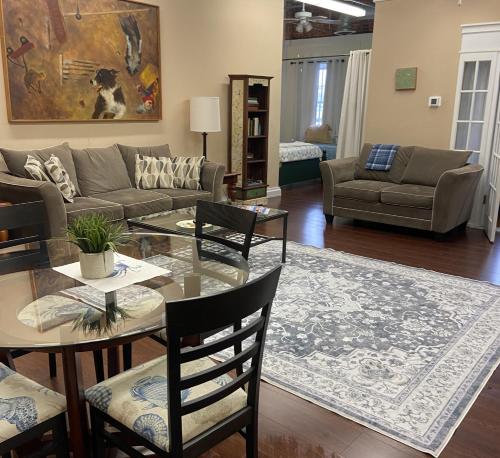 a living room with a couch and a table at 2 bed, 1 bath riverfront loft in Salisbury