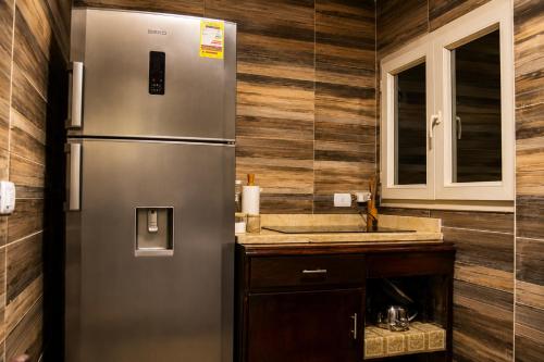 a kitchen with a refrigerator and a sink at Nile Pyramidal view place in Cairo