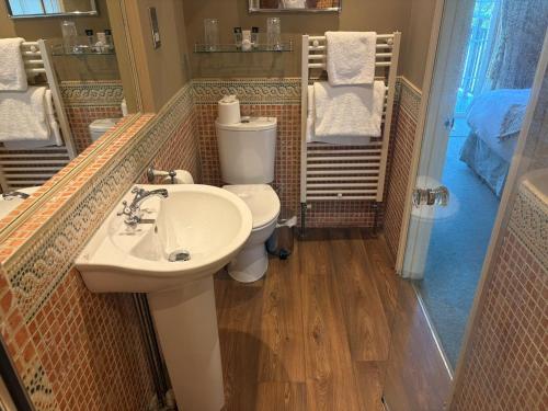 a bathroom with a toilet and a sink at The Hunters Rest Inn in Clutton