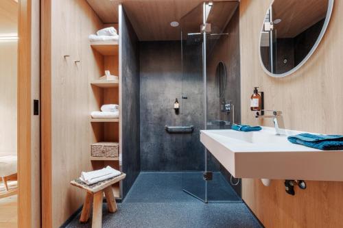 a bathroom with a shower and a sink at Bleu Minuit La Source in Wolxheim