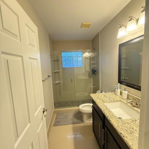 a bathroom with a shower and a toilet and a sink at Luxury and Comfort in Coconut Creek