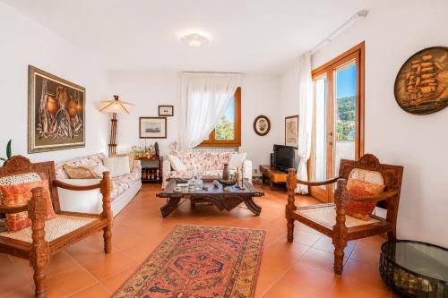 a living room with a couch and chairs at Casa Aldrovandi in Capoliveri