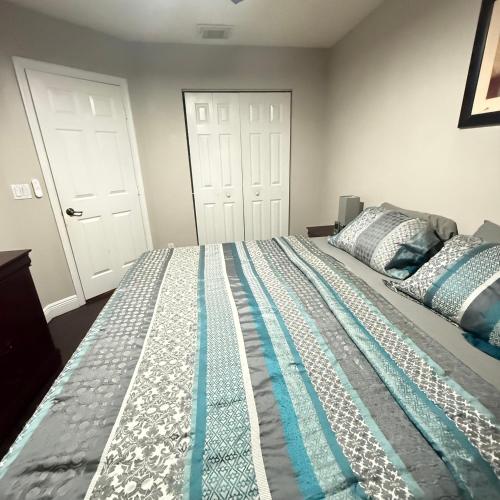 a bedroom with a large bed with two white doors at Luxury and Comfort in Coconut Creek