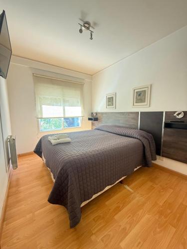a bedroom with a large bed in a room at Este Apart in Bahía Blanca