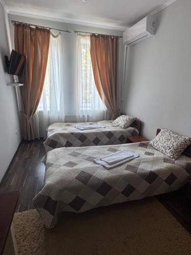 a bedroom with two beds and a window at Готель Пісня Гір in Ralevka