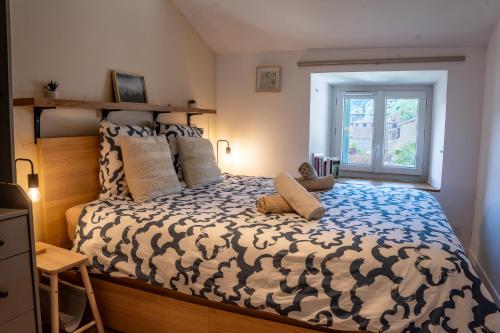 a bedroom with a large bed and a window at Appartement central - L'ouest in Tarare