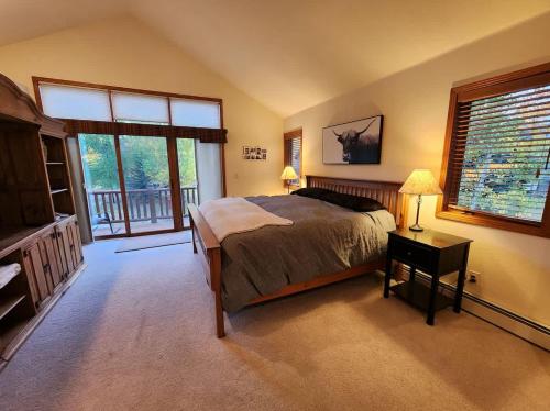 a bedroom with a bed and a large window at Townhome 4BR/4BA in Silverthorne in Silverthorne