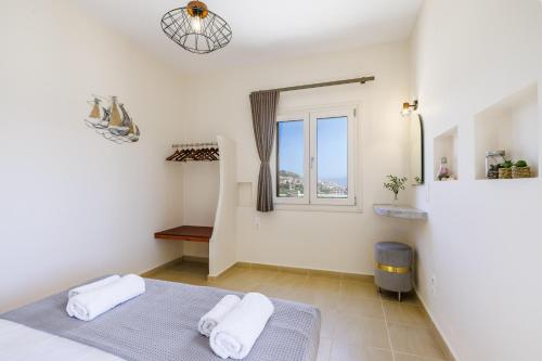 a bedroom with a bed and a window at Villa Anatoli in Skopelos Town