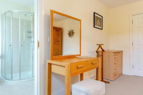 a bathroom with a wooden vanity and a mirror at 3 Bed in Hawes oc-ds967 in Hawes