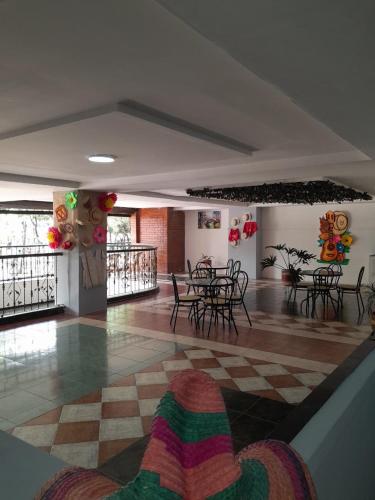 a room with tables and chairs in a building at Hotel Santander Plaza in Neiva