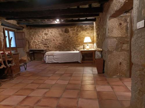 a room with a bed and a table in a building at Casa Villamiel in Villamiel
