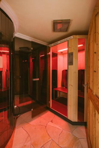 a room with glass doors with a chair in it at Hotel Tiroler Adler in Lutago