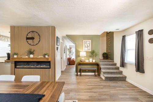 a living room with a table and a fireplace at Charming Farmhouse Getaway 7 Beds in Centerville