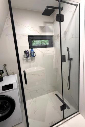 a shower with a glass door in a bathroom at View Retreat in Visoko