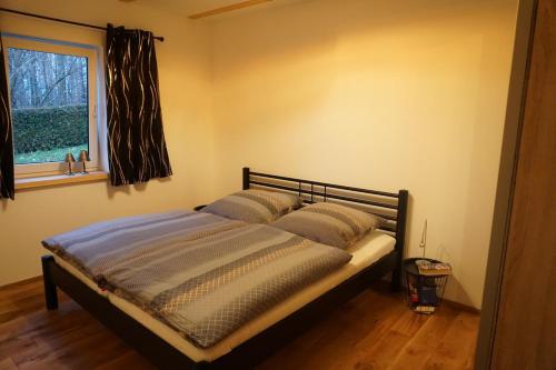 a bed in a bedroom with a window at Live your dream in Kirchberg