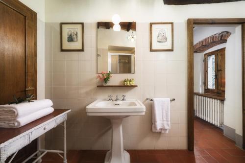 a bathroom with a sink and a mirror at Castello di Albola in Radda in Chianti